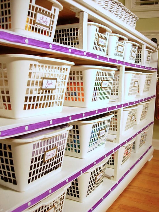 Ribbon trim along front of dresser with white baskets inside to use as organized storage.