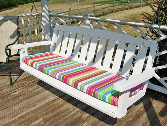 Porch swing after getting a paint makeover and new no sew cushion that can be made in minute