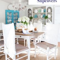 dining room with white chairs and white DIY made slipcovers