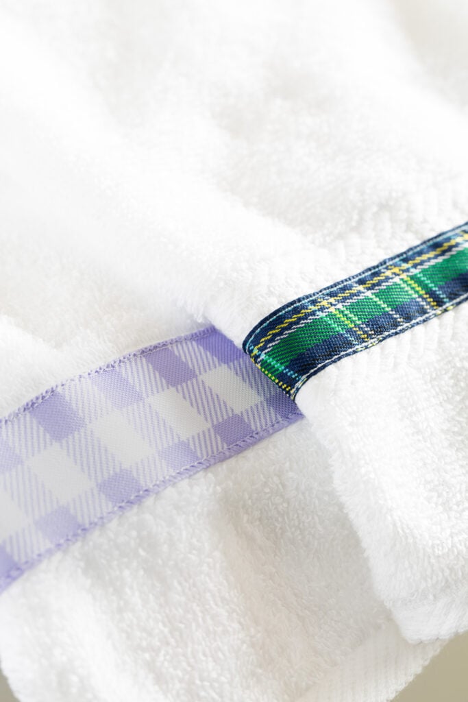 close up ot added ribbon on white bath towels.