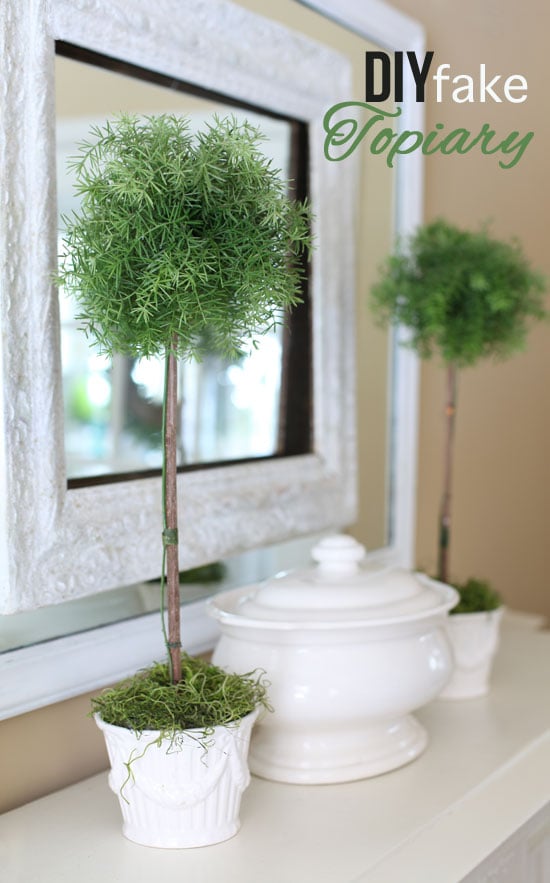 How to make a fake topiary that looks real. Two DIY topiaries on sideboard with mirror behind them.