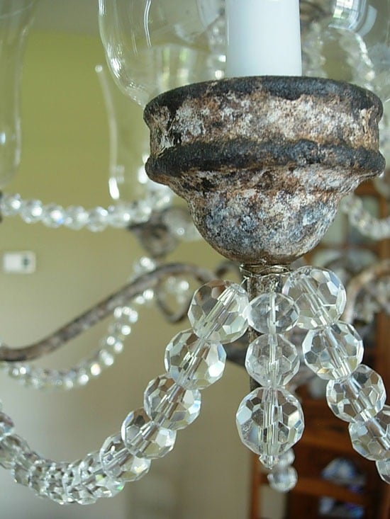 close up of rusted painted finish n a brass chandelier