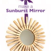 Mirror framed in clothespins and hung with purple ribbon