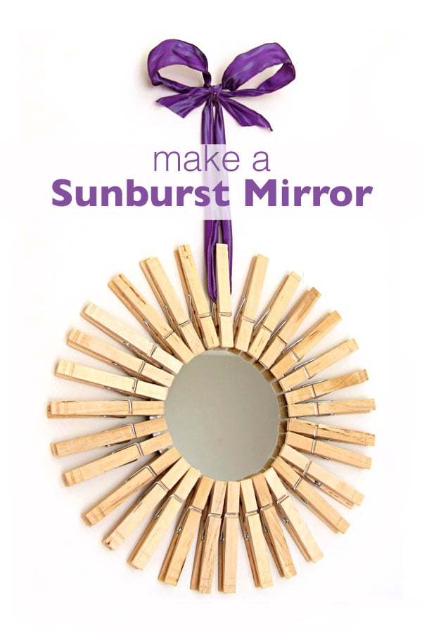 Mirror framed in clothespins and hung with purple ribbon