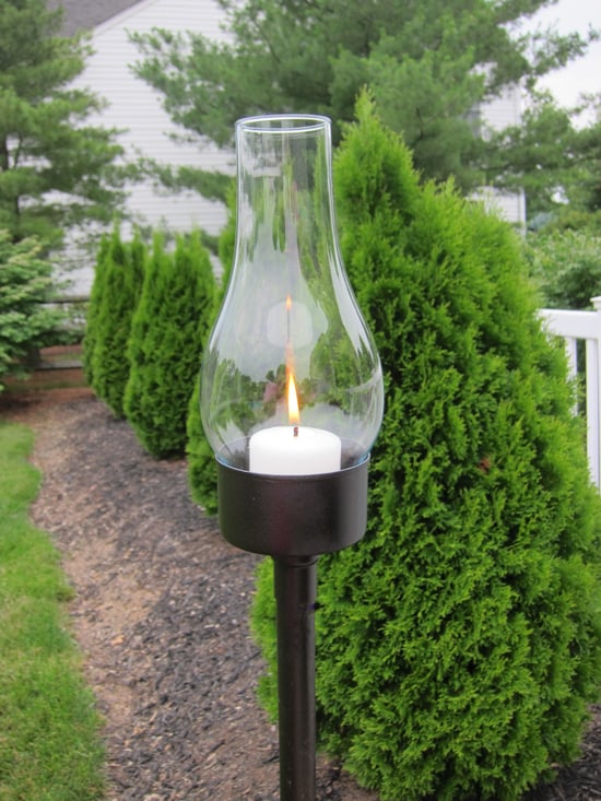 DIY outdoor lantern with glass globe made using a tuna can.