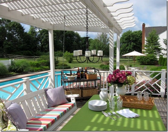 Outdoor deck set up for a party and showing a DIY hanging light.