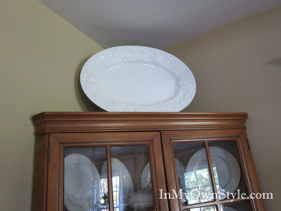 How to add height to decorative items on top of wall cabinets and hutches.
