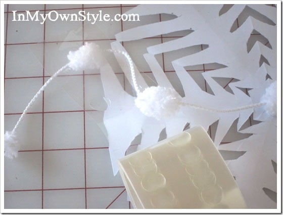 putting-glue-dot-on-pom-pom