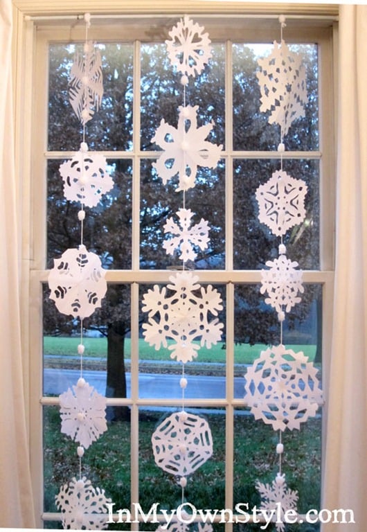 Paper snowflakes hanging in a window