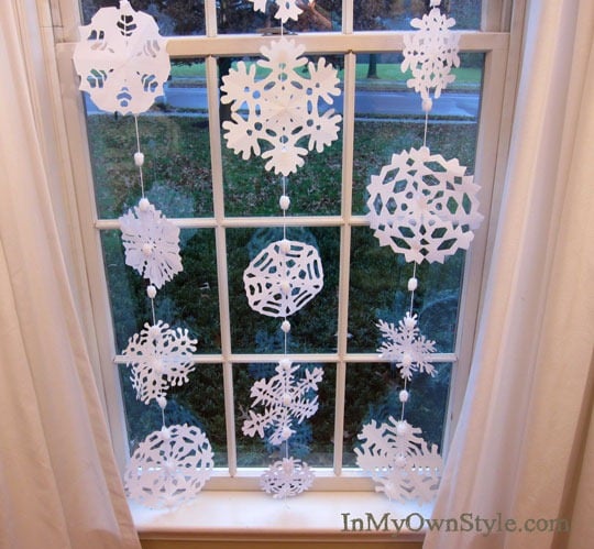 paper snowflakes hanging in a window