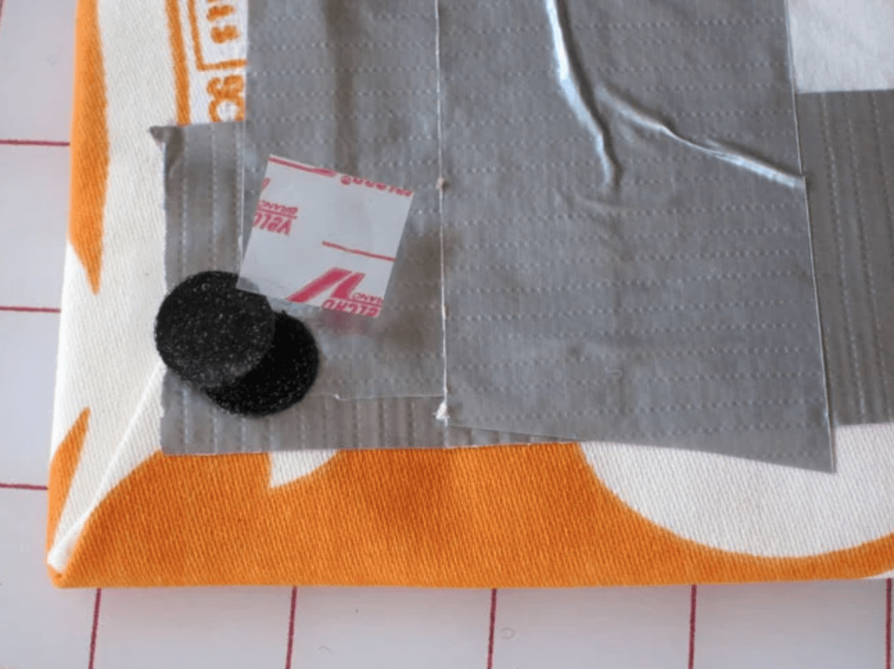 Add velcro tabs to the back of the fabric and ribbon covered board