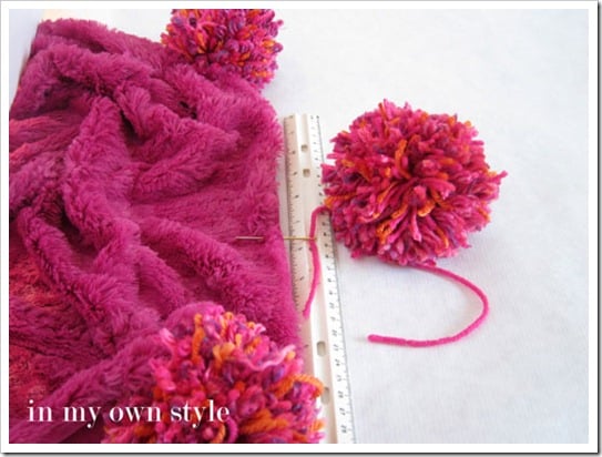 How to add a pom pom to the edge of fabric or a blanket
