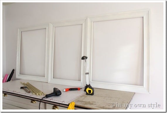 Empty-frames lined up along wall to figure out placement.
