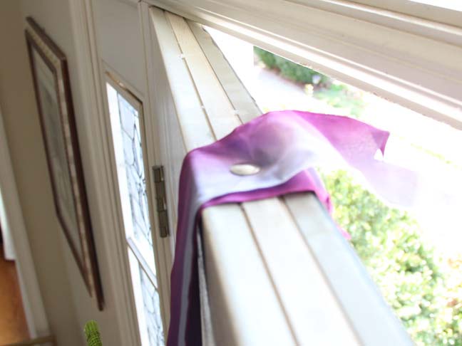 How to hang a wreath the easy way on a door with ribbon.