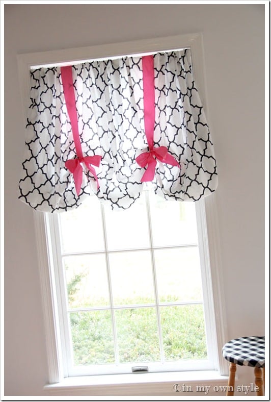 No sew fitted sheet on window with pink ribbons.