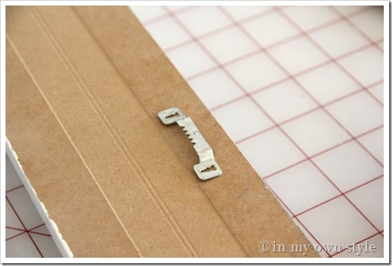 Sawtooth hanger on the back of gift wrap organizer frame. 