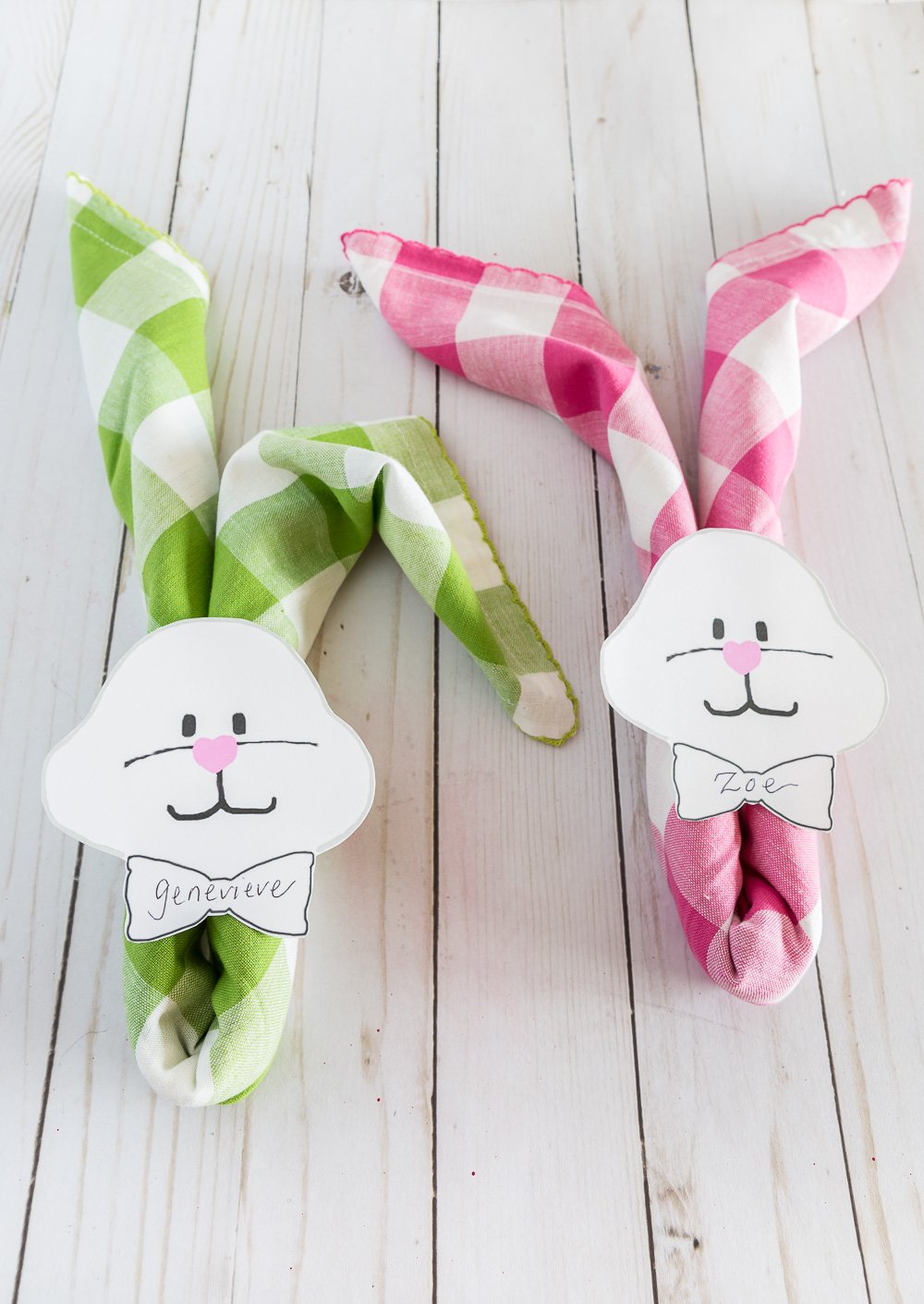 Pastel Buffalo check napkins rolled and placed over rolled napkins with bunny face and bowtie to use as a place card.