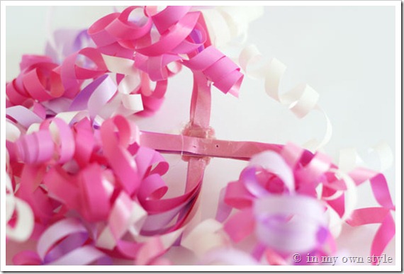 Showing where to place candle holder under ribbon.