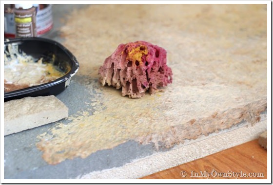 sea sponge used to paint grey concrete hearth
