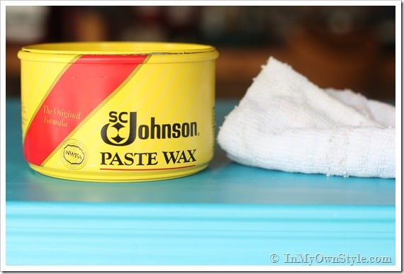 Johnsons Paste Wax can and soft buffing cloth on top of newly painted chest of drawers.