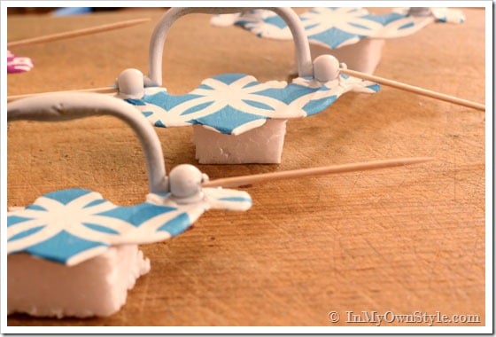 Cabinet knob makeovers - how to allow them to dry using toothpicks to hold up the pull.