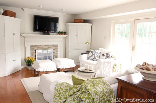 White decorated living room with hardwood floors. 