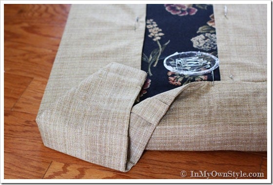 Using common household items to make a fabric cover for a cushion.