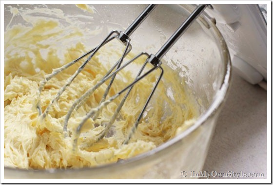 Christmas-cookies being beaten in a mixing bowl.