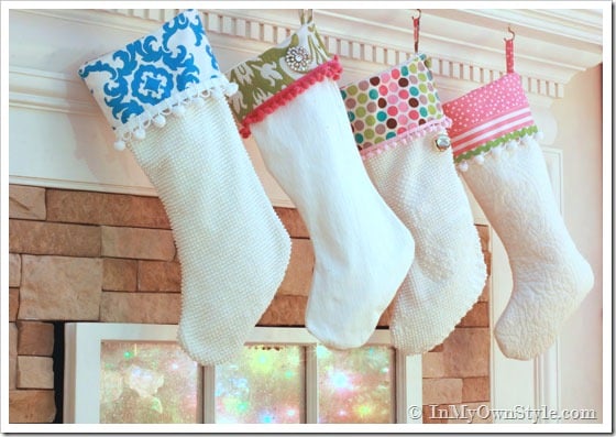 Colorful holiday stockings hanging along a mantel