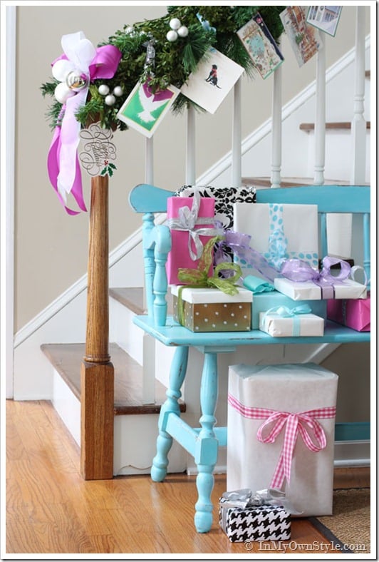Christmas cards tied on staircase garland using ribbon and garland ties