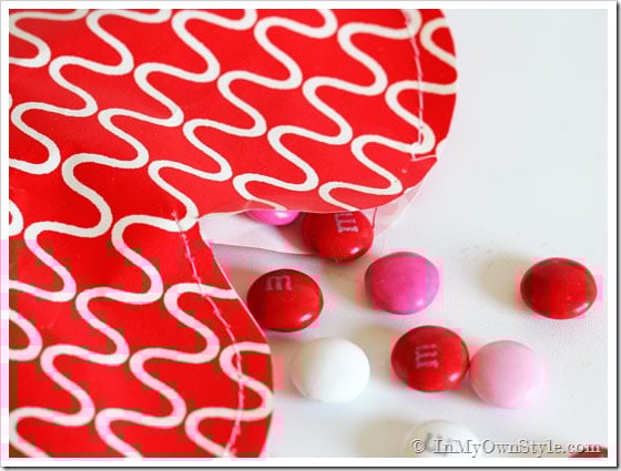 Red gift wrap paper made into a heart candy pouch.