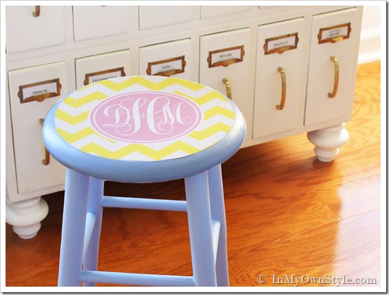 vintage wood stool painted with monogram decal on seat.