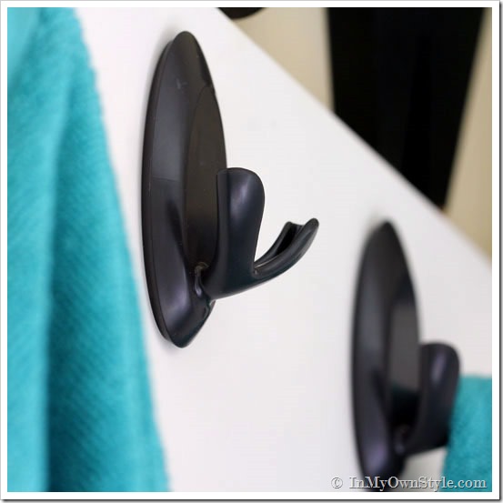 Towel hooks on wall displayed in a decorative way