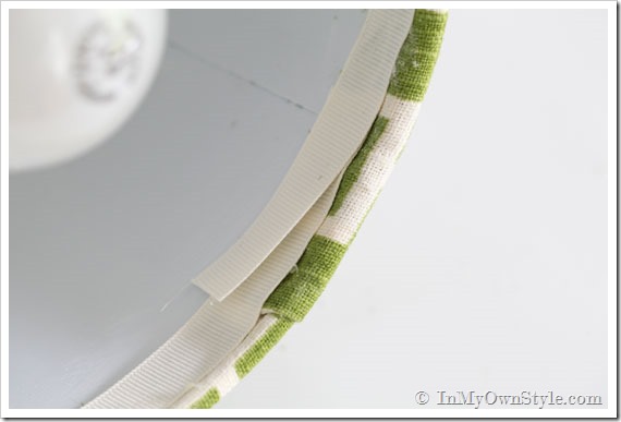Decorating-details-trim-a-fabric-covered-lampshade-with-ribbon