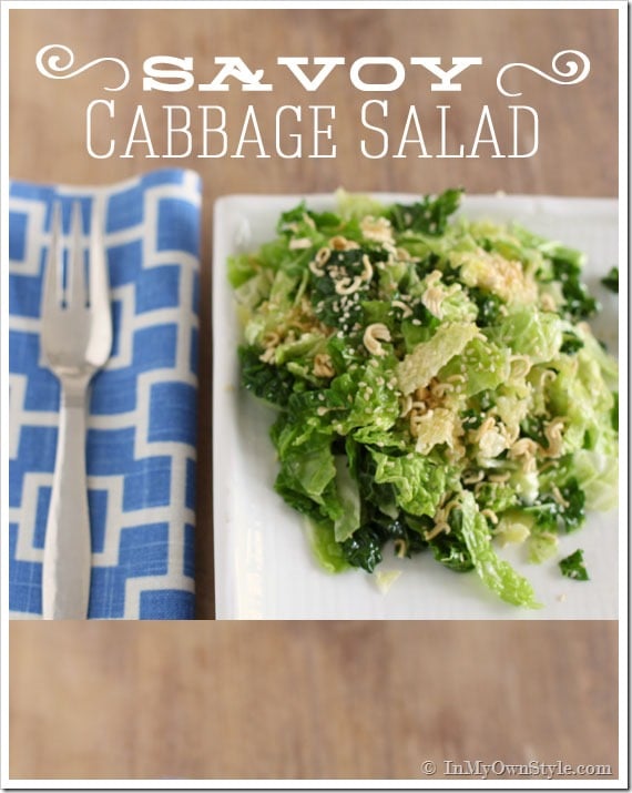 Savoy-Chinese-Cabbage-Salad-Recipe shown on a plate on table with blue and white napkin and fork.  It is a kid friendly dinner party menu staple.