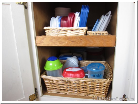 Kitchen Cabinet Organizing Idea showing small baskets hold plasticware.