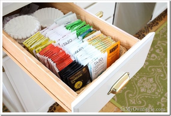 Organizing teabags and coffee filters in drawer with a basket.