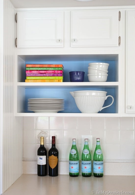 Open shelves in kitchen with removable backdrops of color.