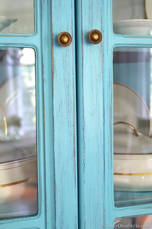corner cabinet painted with DIY chalk paint using two colors