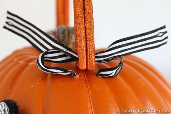 Attach ribbon on pumpkin