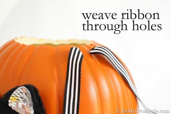 weave ribbon through the holes in the pumpkin