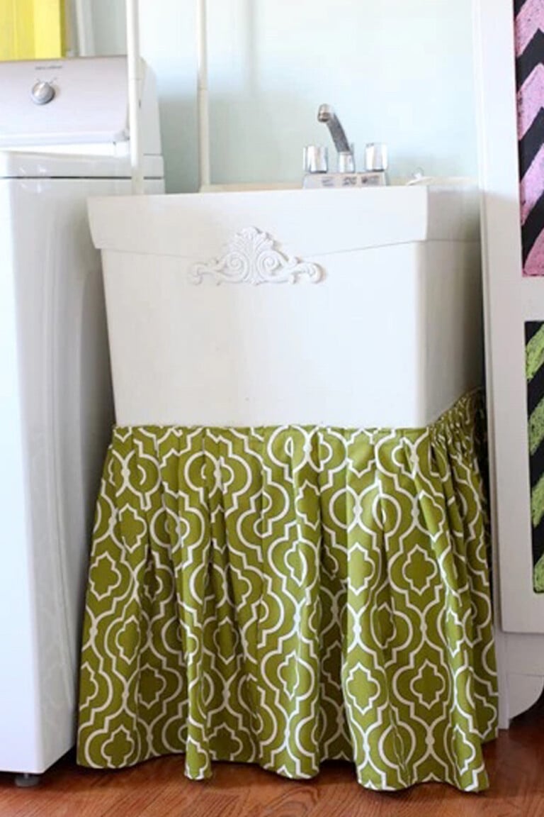 slop sink with pretty fabric sink skirt around bottom.