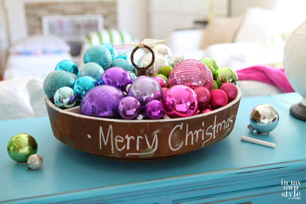 Christmas ornaments in a large bowl on a table.