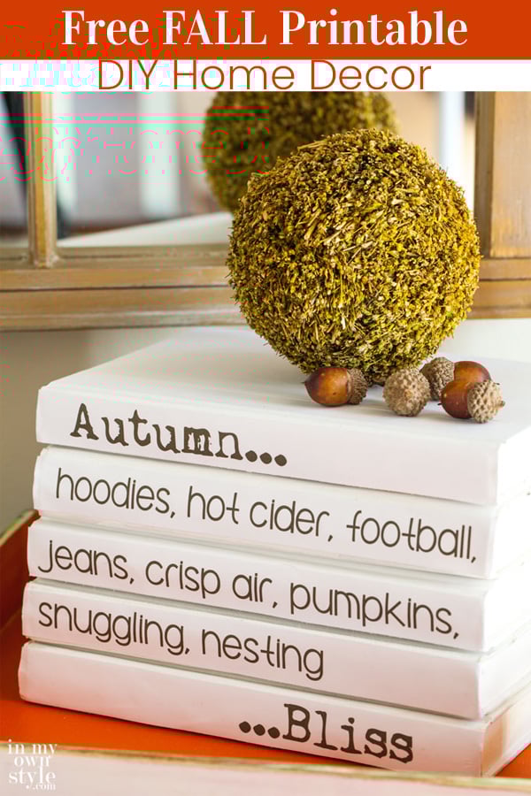 A stack of white books on a table top with fall sayings on the bindings. Free printable to download to use