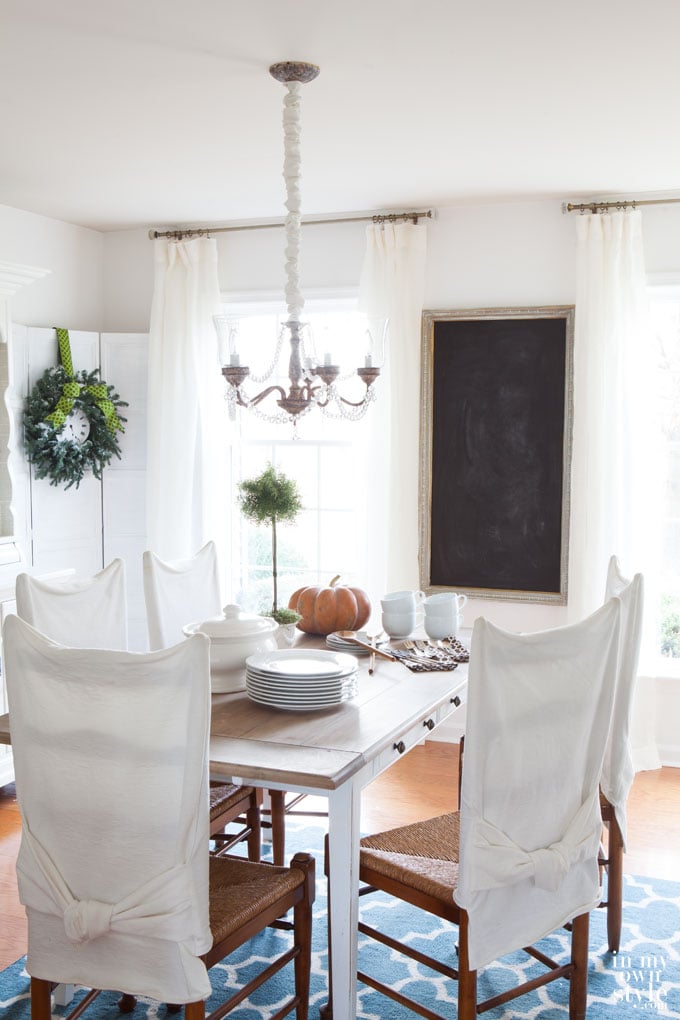 Dining room with white drapes and chalk painted table