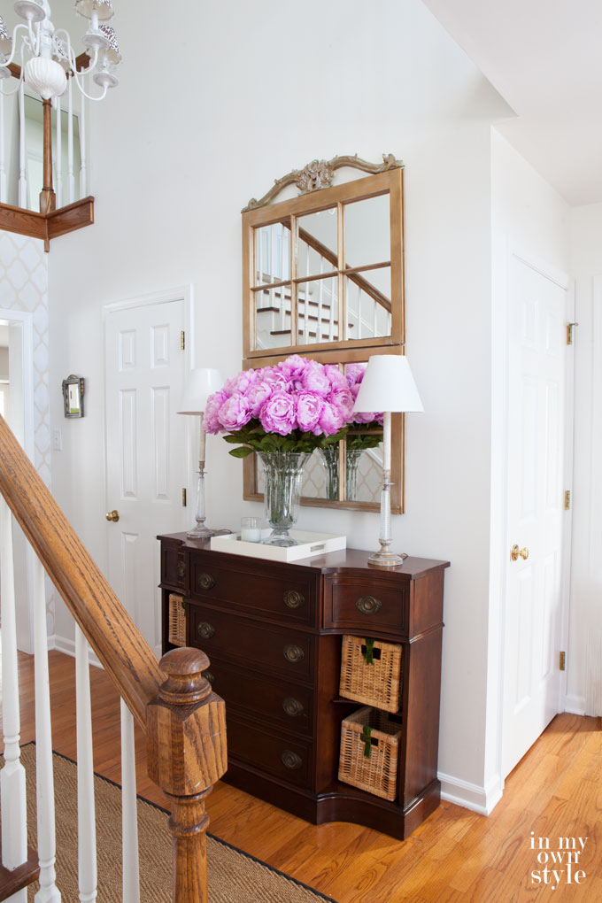 How to add impact when decorating without spending a lot of money. Repurpose old wood windows to make a large mirror in an entryway to greet your family and guests.