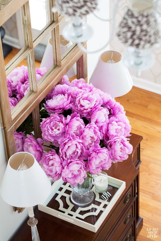 Decorating idea using old window frames in a foyer. Use one or more to make a large decorative mirror. 