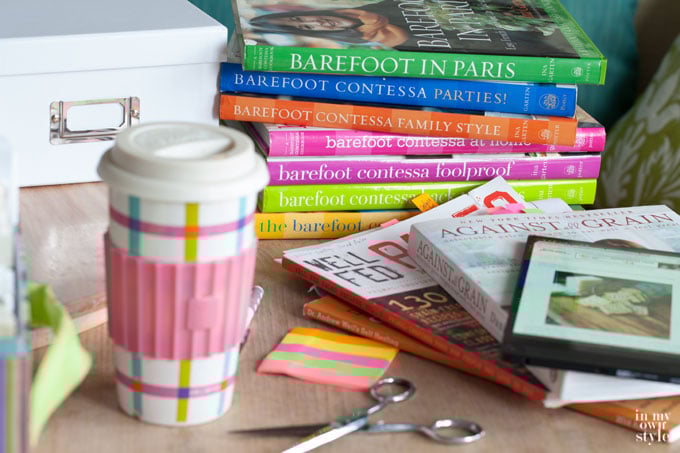 Cook book and recipe box organizing marathon with big coffee mug on table.