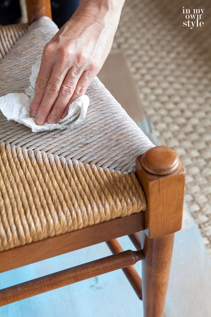 Wiping-off-stain-on-dining-room-rush-seat-chair