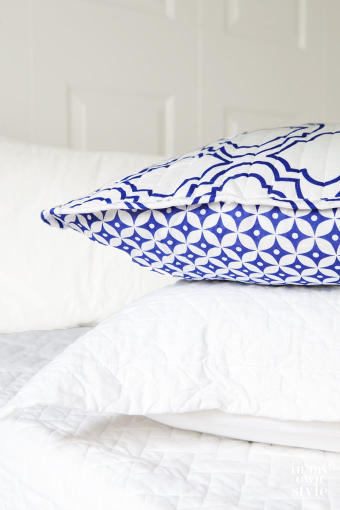 Blue and white bed pillow shams with reversible design.